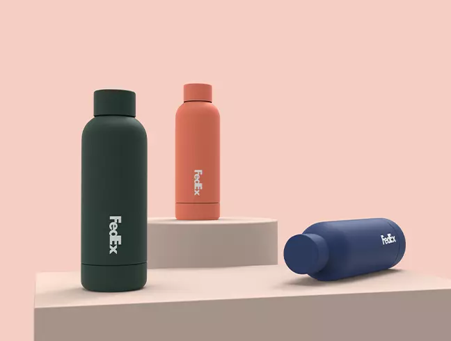 Matte water bottles in three colours carrying a courier-style wordmark