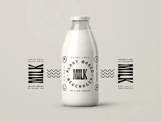 White milk bottle with experimental black typography on a cream backdrop